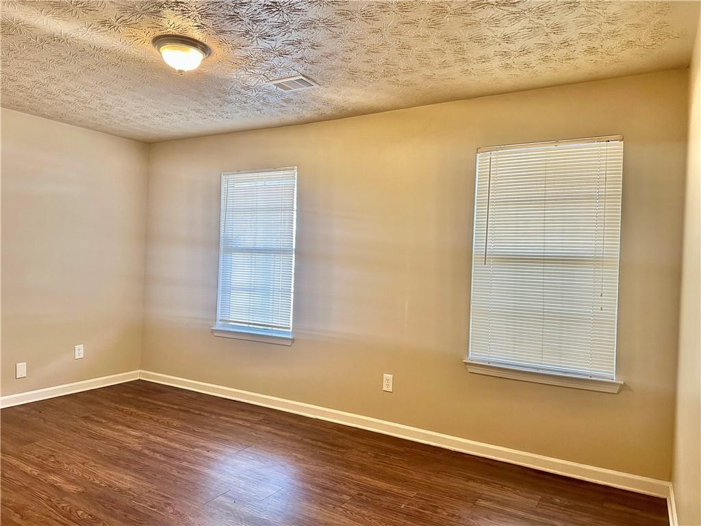 2603 Old Rex Morrow Road Ellenwood, GA 30294 - Photo 11 of 17 an empty room with wooden floor and windows