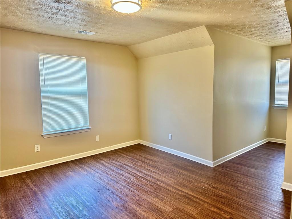 2603 Old Rex Morrow Road Ellenwood, GA 30294 - Photo 14 of 17 a view of an empty room with wooden floor and a window