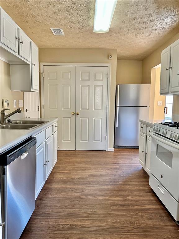 2603 Old Rex Morrow Road Ellenwood, GA 30294 - Photo 4 of 17 a kitchen with stainless steel appliances a sink and a refrigerator
