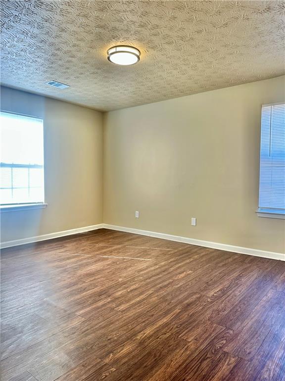 2603 Old Rex Morrow Road Ellenwood, GA 30294 - Photo 8 of 17 a view of an empty room with wooden floor and a window