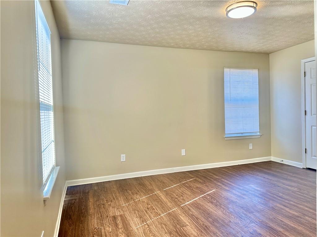 2603 Old Rex Morrow Road Ellenwood, GA 30294 - Photo 9 of 17 a view of an empty room with wooden floor and a window