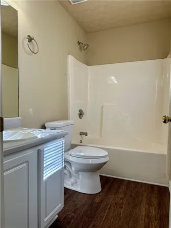 a bathroom with a sink a toilet and bathtub