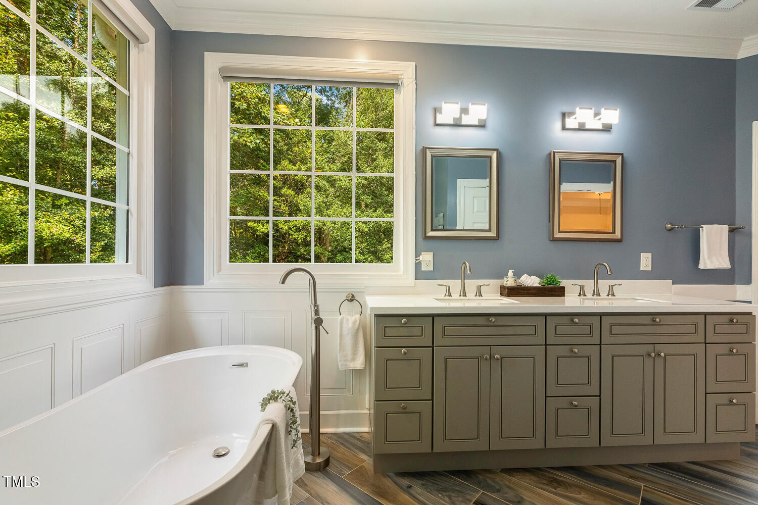 1505 October Road Raleigh, NC 27614 - Photo 24 of 76 a bathroom with a tub sink double vanity and windows