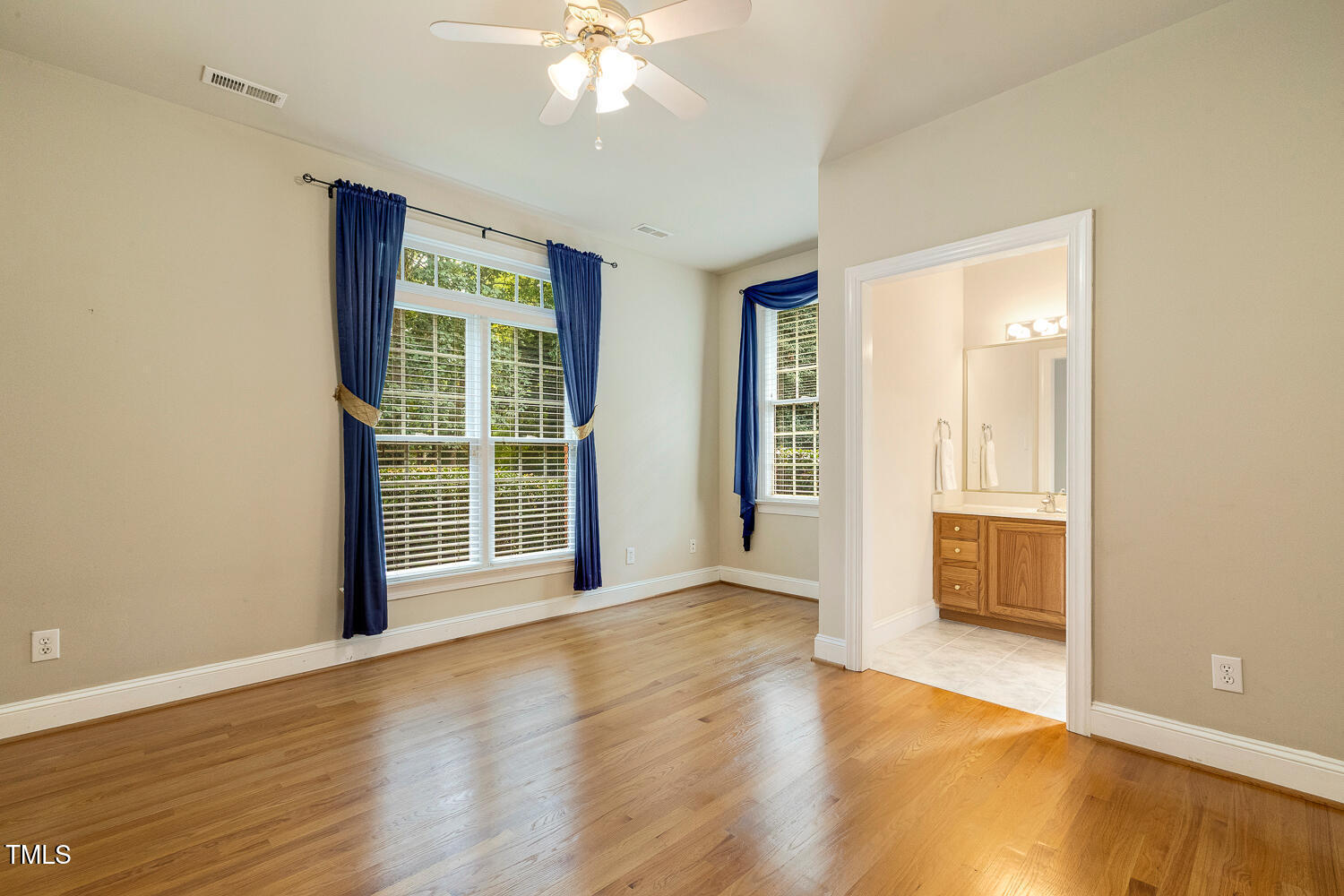 1505 October Road Raleigh, NC 27614 - Photo 27 of 76 a view of an empty room with wooden floor and a window