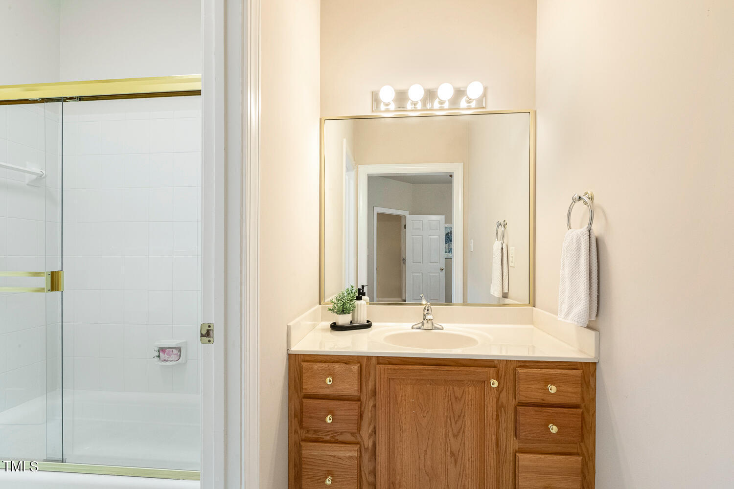 1505 October Road Raleigh, NC 27614 - Photo 29 of 76 a bathroom with a double vanity sink and a mirror