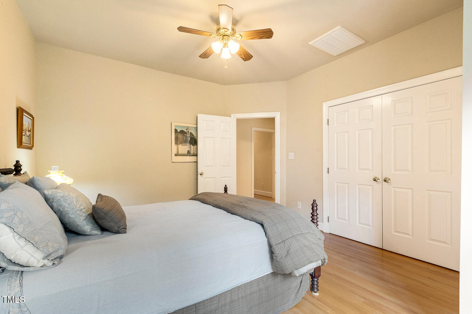 1505 October Road Raleigh, NC 27614 - Photo 31 of 76 a bedroom with a bed and a chandelier
