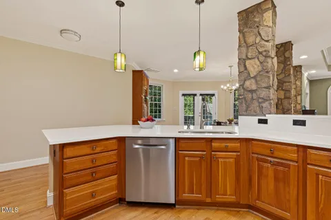 a bathroom with a tub sink double vanity and windows