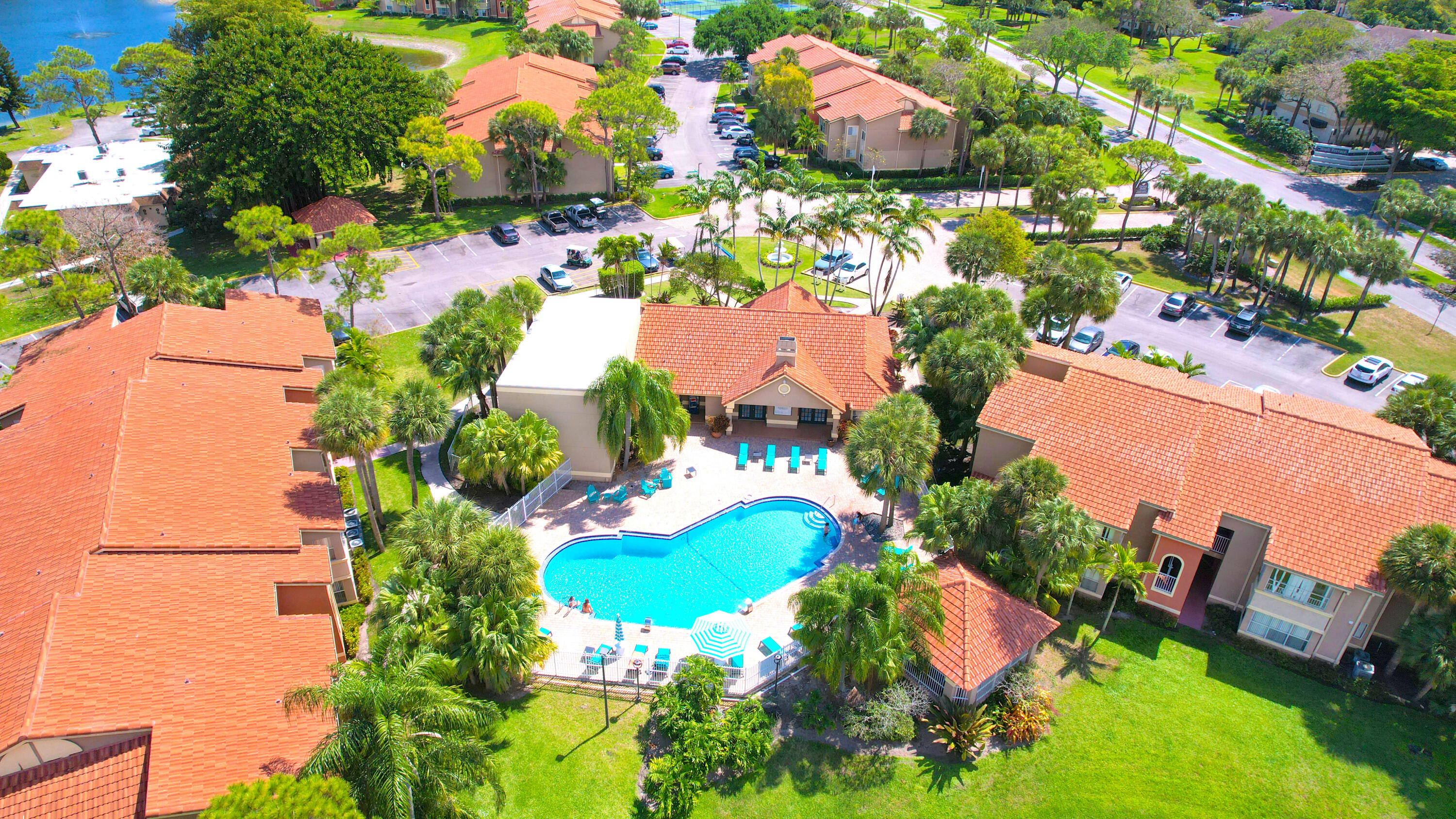 an aerial view of a house with a yard and lake view in back