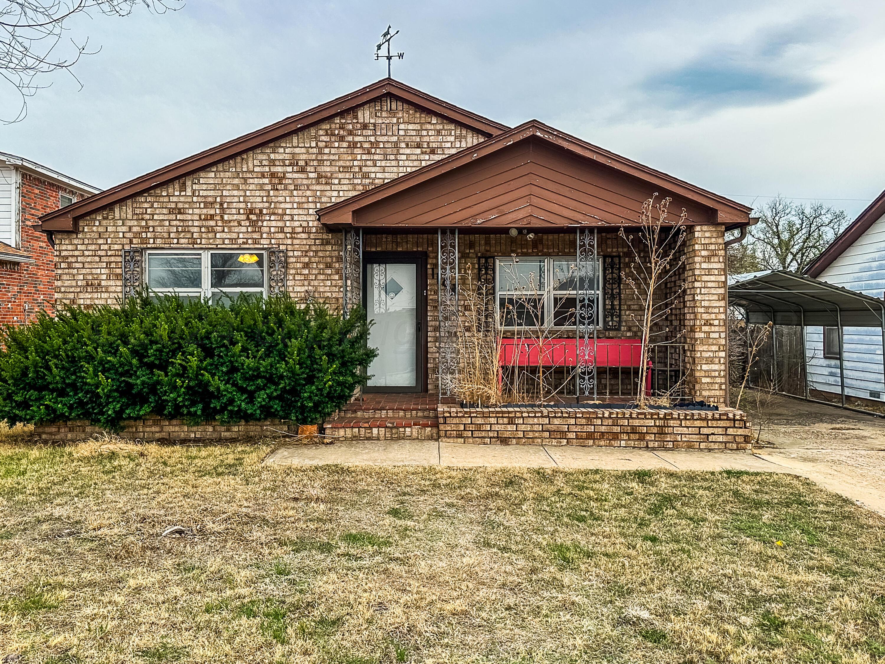 1103 Madison Street Borger, TX 79007 - Photo 1 of 16 a front view of a house with a yard