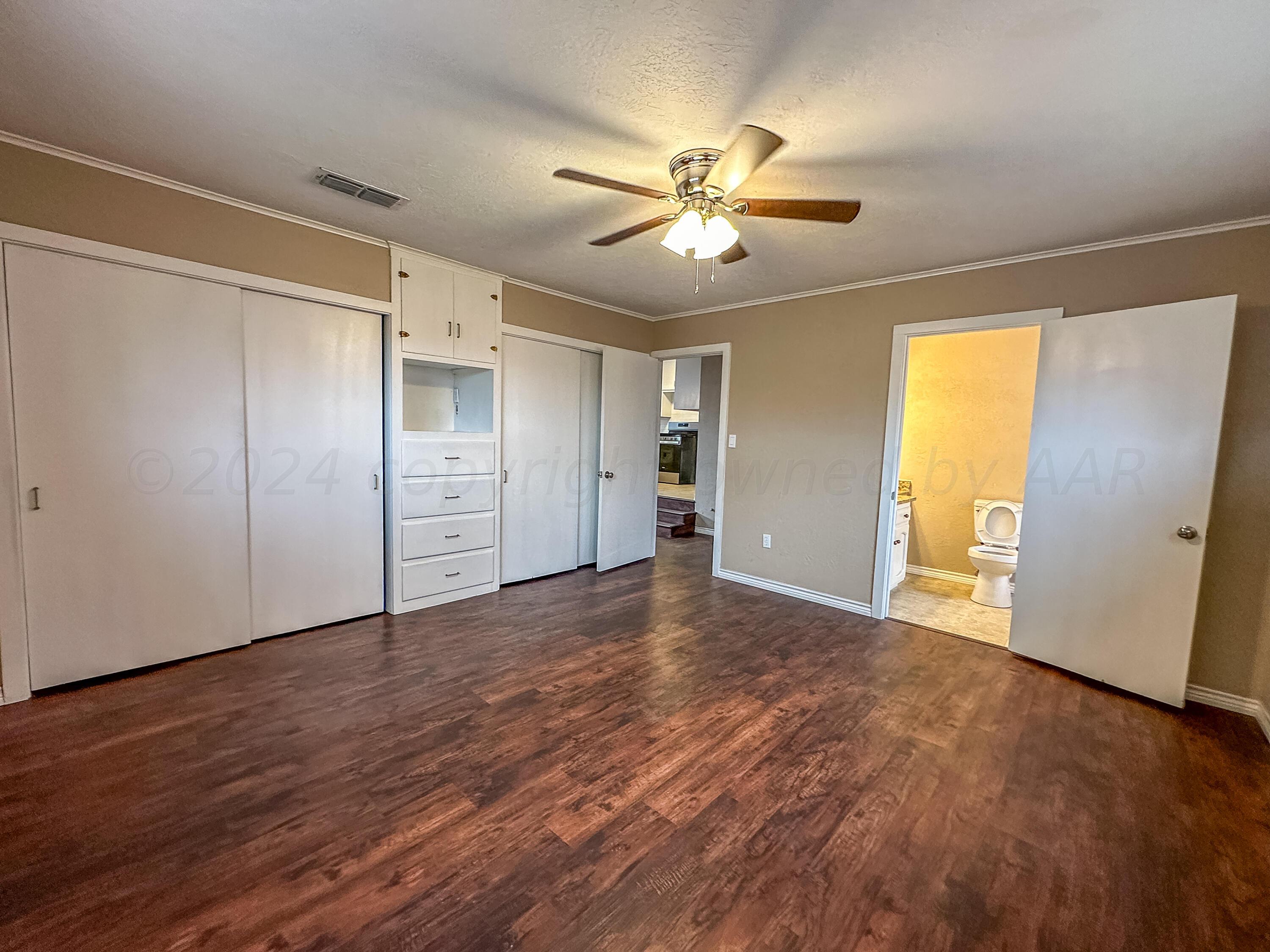 1103 Madison Street Borger, TX 79007 - Photo 14 of 16 a view of an empty room with wooden floor and window