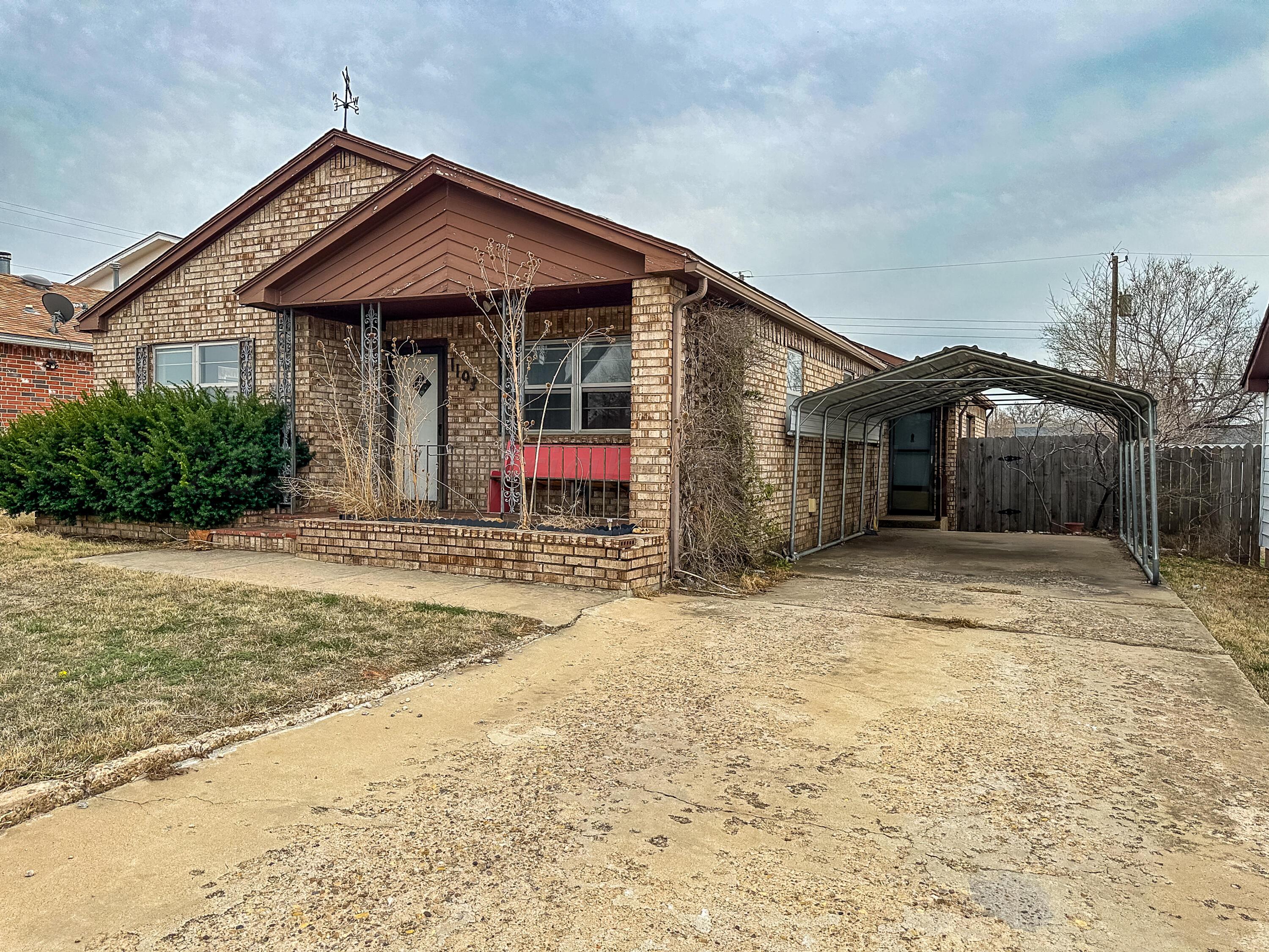 1103 Madison Street Borger, TX 79007 - Photo 2 of 16 a front view of a house with garden