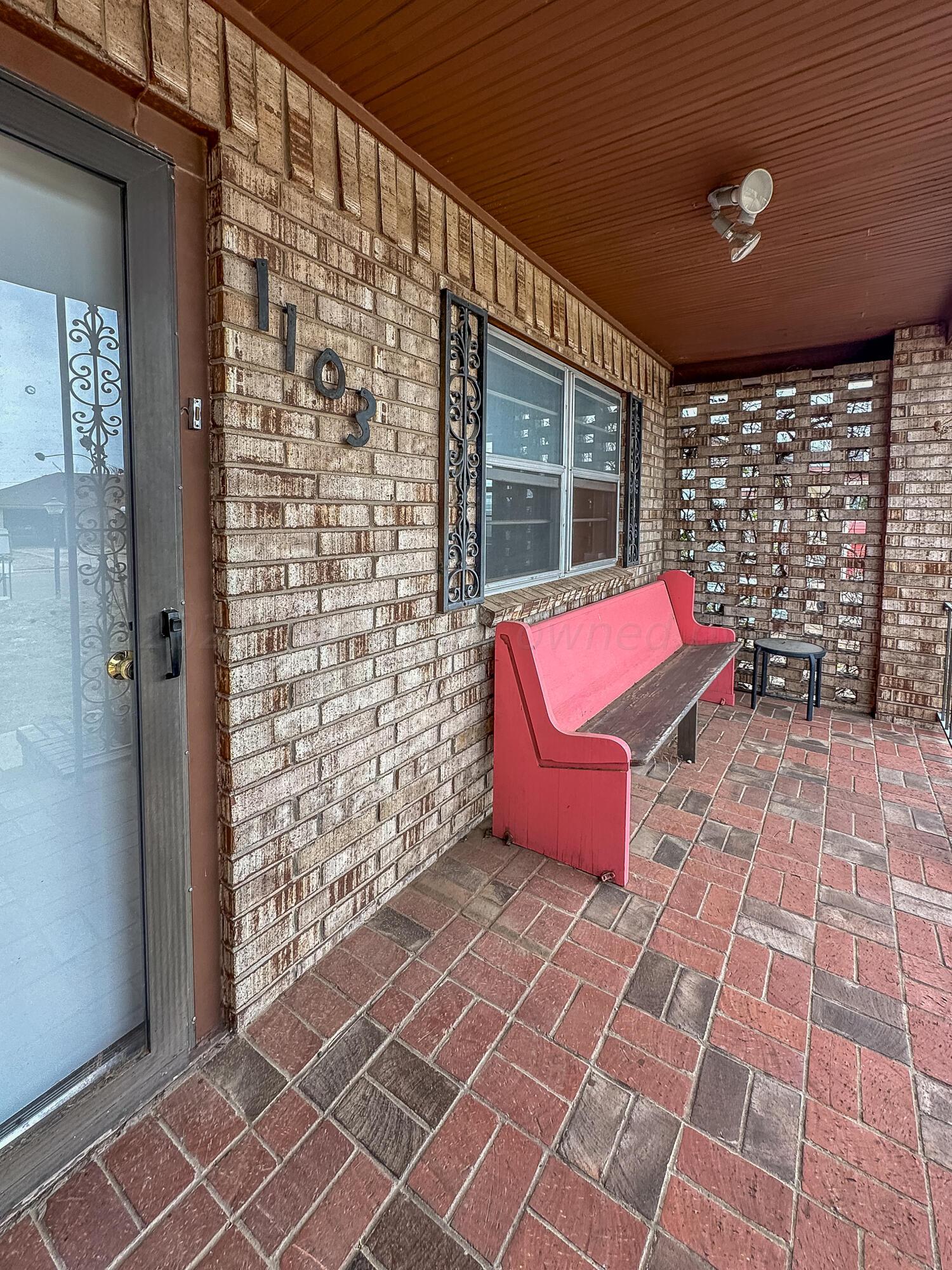 1103 Madison Street Borger, TX 79007 - Photo 3 of 16 a bench sitting in front of a building