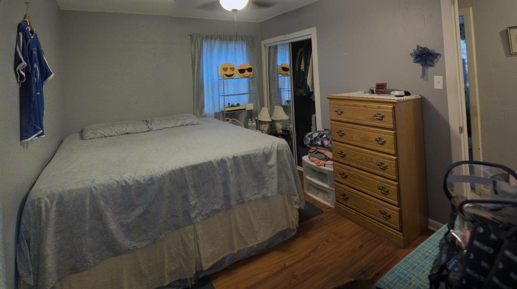 531 Ridgecrest Drive Lewisville, TX 75067 - Photo 2 of 10 a bedroom with a bed and wooden floor