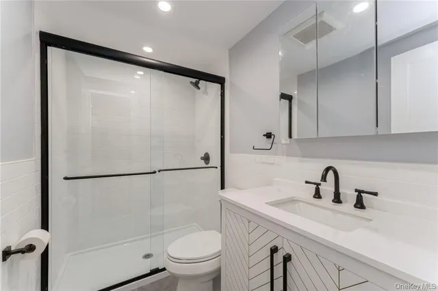 a bathroom with a sink toilet and shower