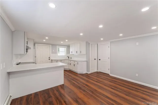 a large kitchen with kitchen island a sink stainless steel appliances and cabinets