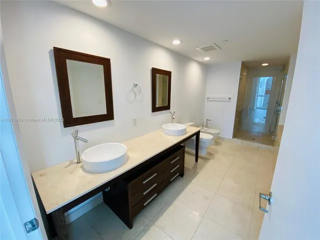 a bathroom with a sink double vanity and a mirror