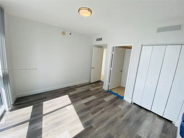 a view of an empty room and wooden floor