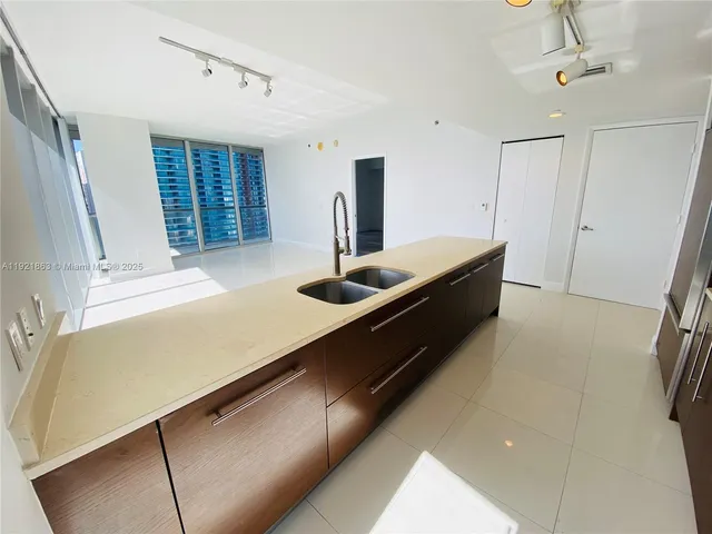 a room with pool table and windows