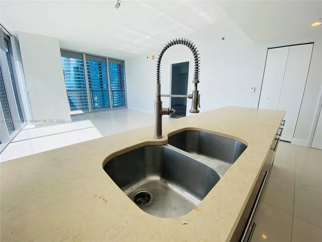 a kitchen with a sink and washing machine