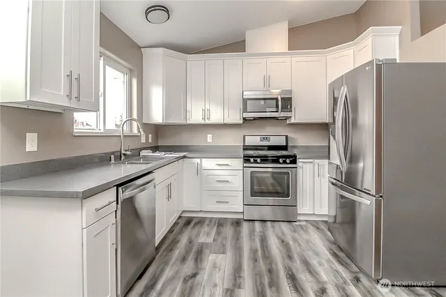 a kitchen with a refrigerator and a sink