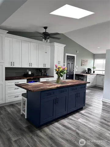 a kitchen with stainless steel appliances granite countertop a sink counter space and cabinets