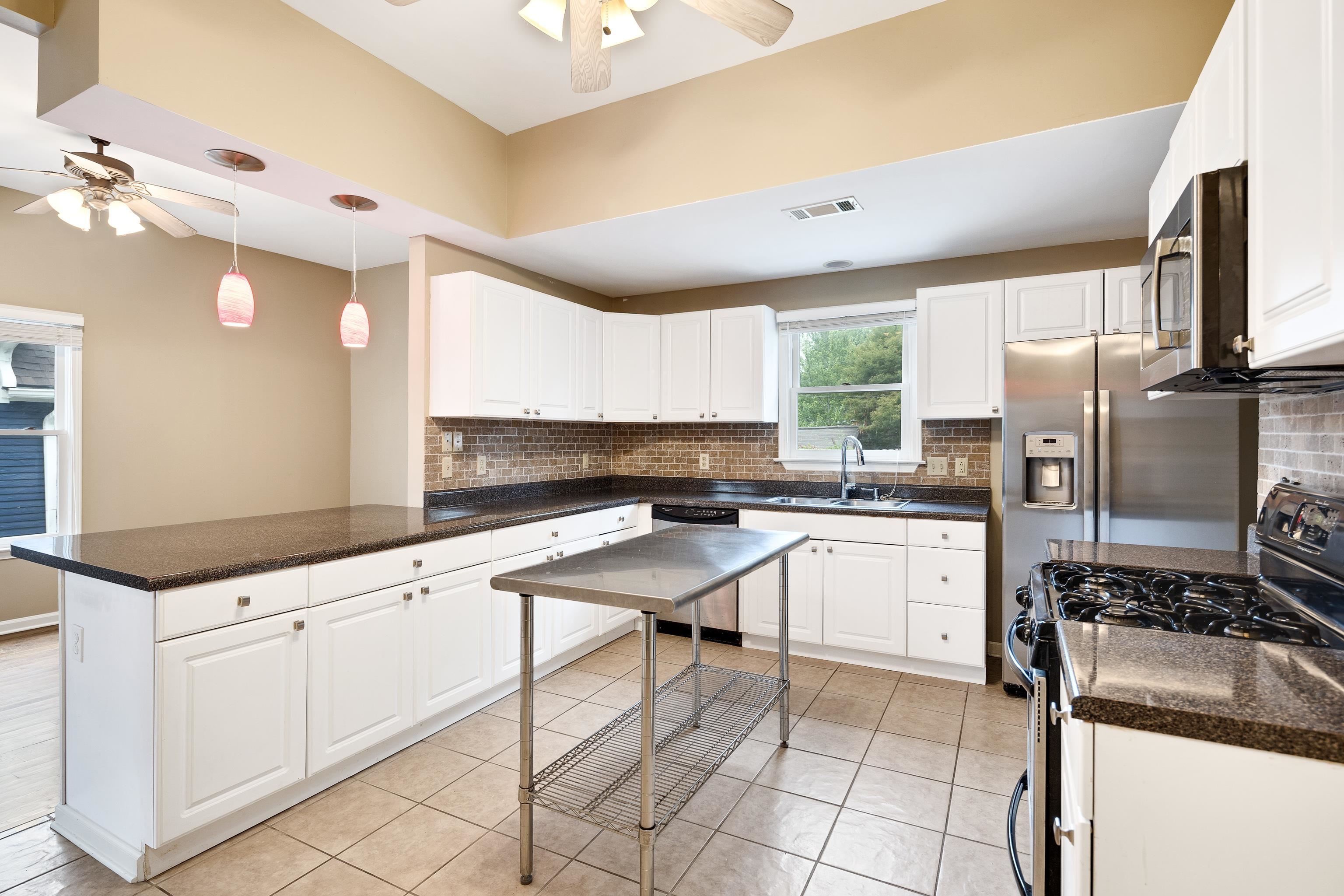 1003 New York Street Memphis, TN 38104 - Photo 15 of 40 a kitchen with granite countertop a sink appliances cabinets and furniture