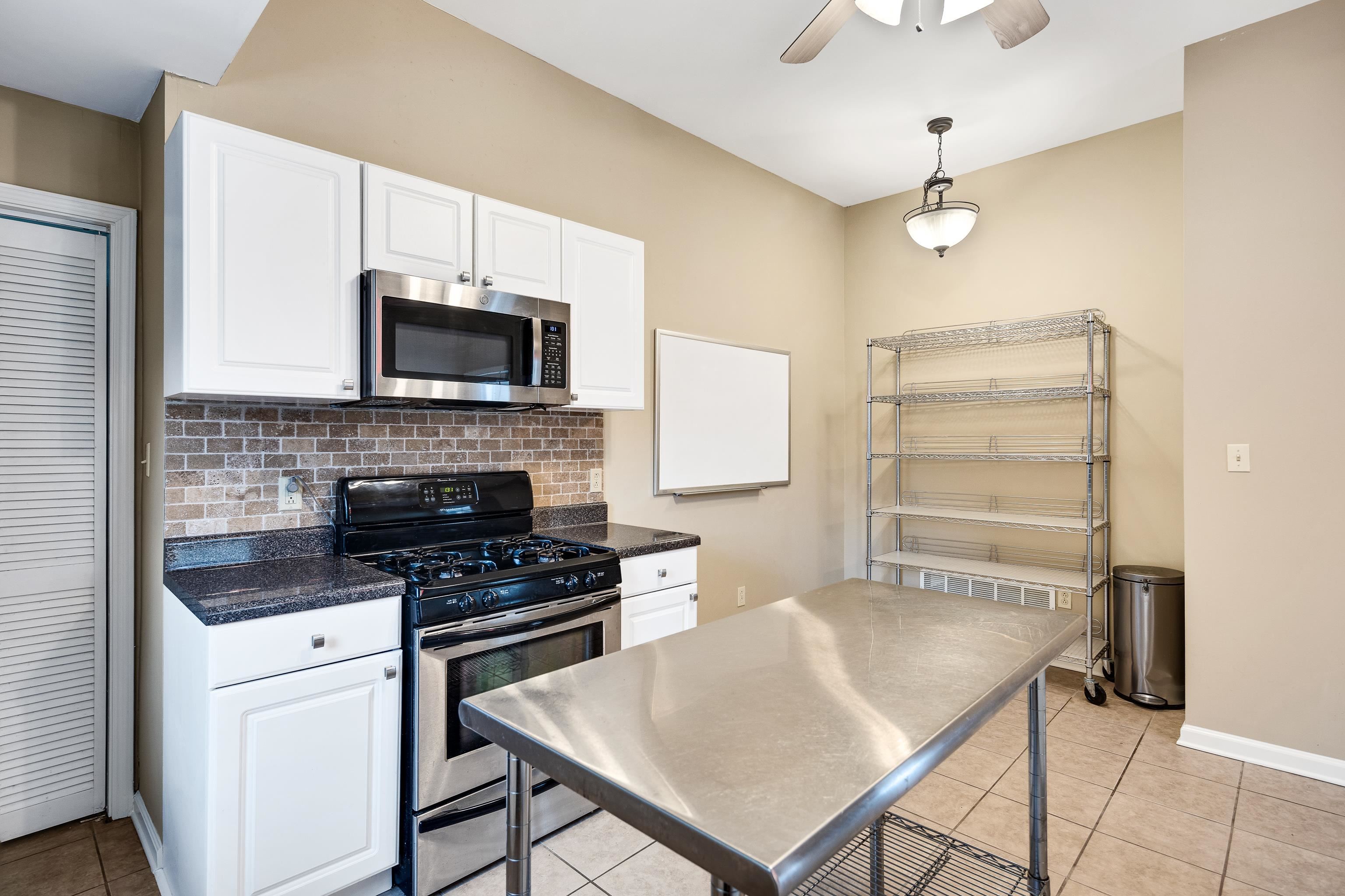 1003 New York Street Memphis, TN 38104 - Photo 17 of 40 a kitchen with cabinets appliances and a counter space