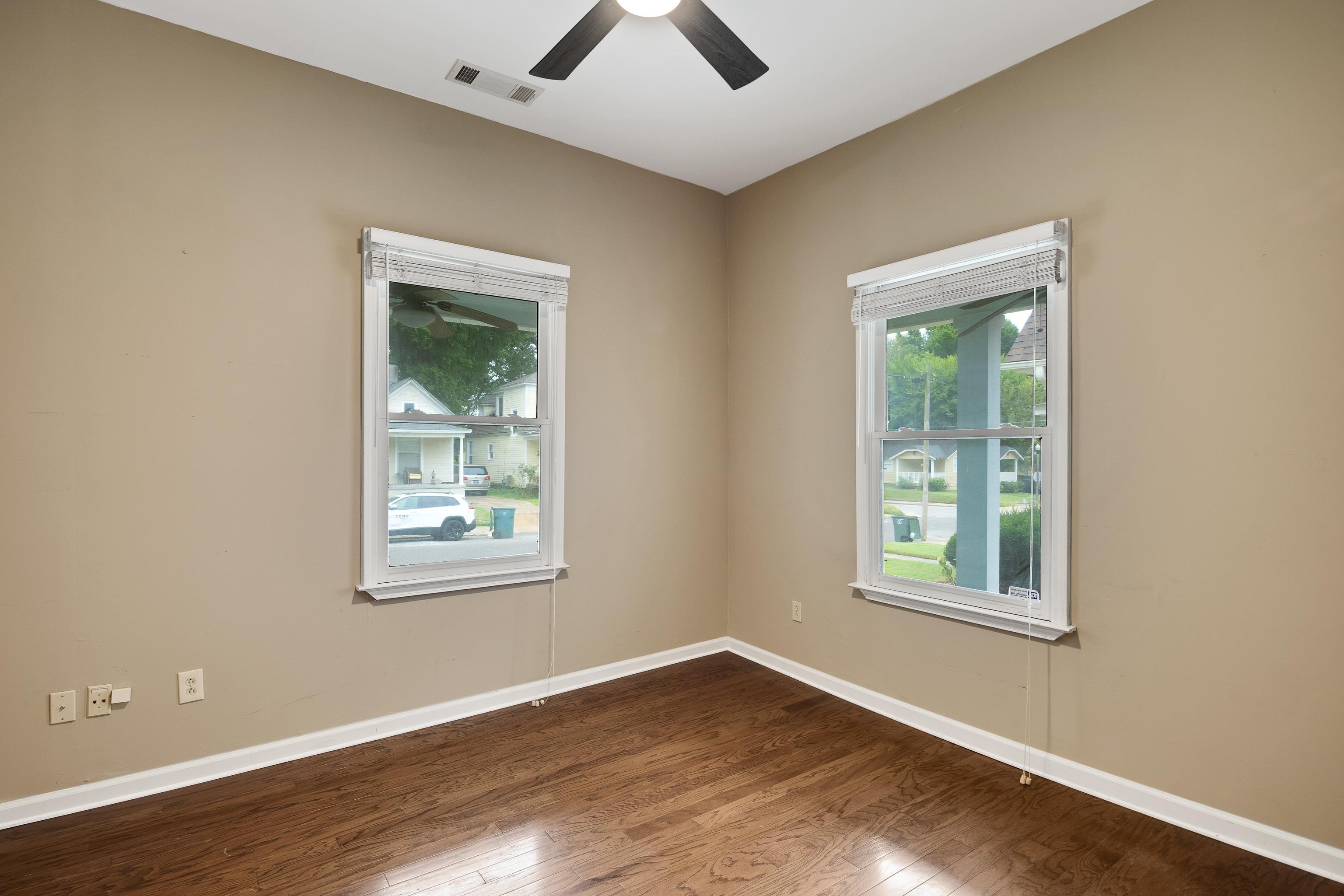 1003 New York Street Memphis, TN 38104 - Photo 20 of 40 an empty room with wooden floor and windows