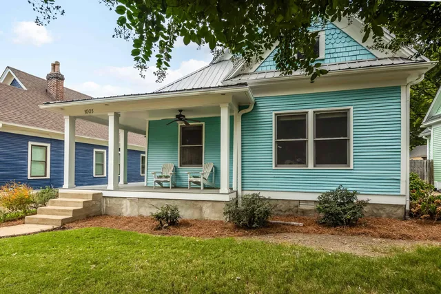 a view of a house with a yard porch and sitting area