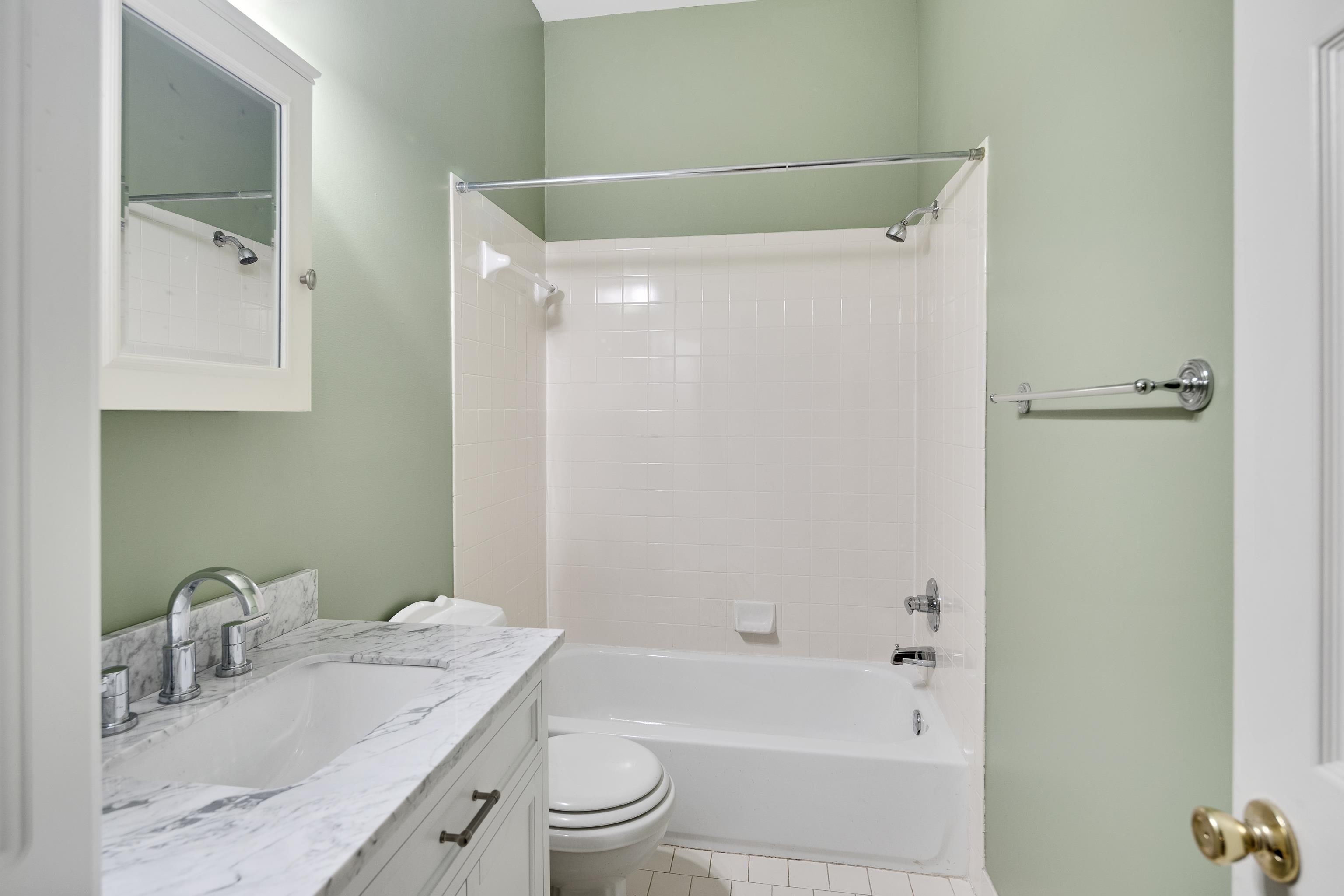 1003 New York Street Memphis, TN 38104 - Photo 24 of 40 a bathroom with a granite countertop bathtub shower sink vanity and toilet