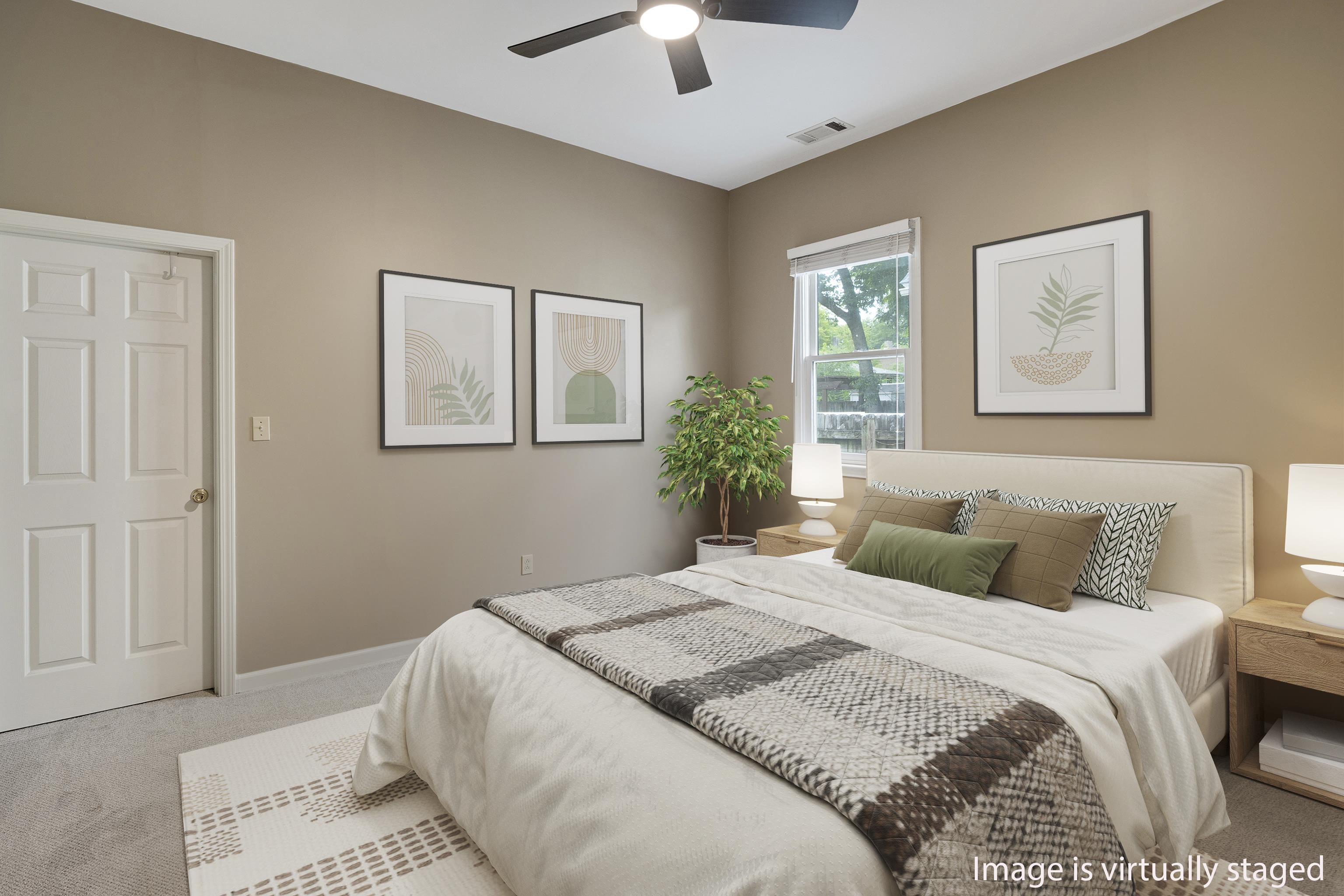 1003 New York Street Memphis, TN 38104 - Photo 26 of 40 a bedroom with a bed and a chandelier