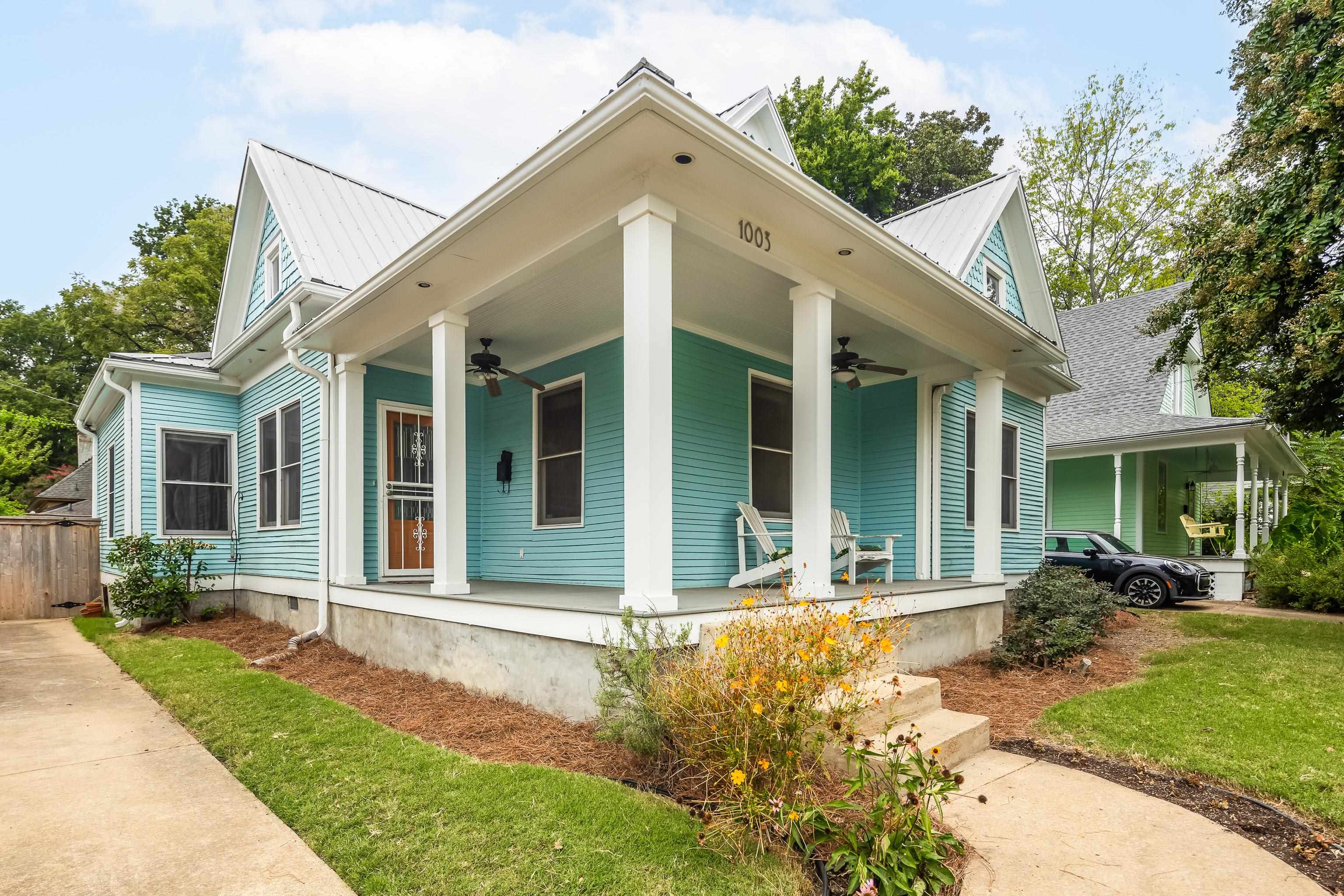 1003 New York Street Memphis, TN 38104 - Photo 3 of 40 a view of a white house with a large windows and a yard with plants