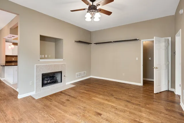 wooden floor fireplace and windows in a room
