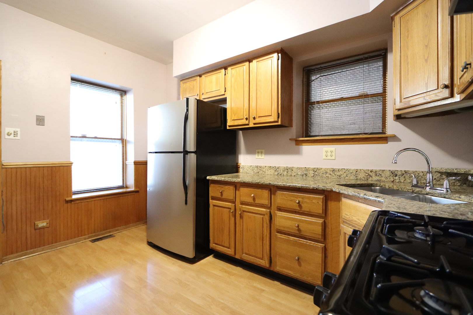 3217 South May Street Chicago, IL 60608 - Photo 11 of 27 a kitchen with granite countertop a refrigerator and a sink