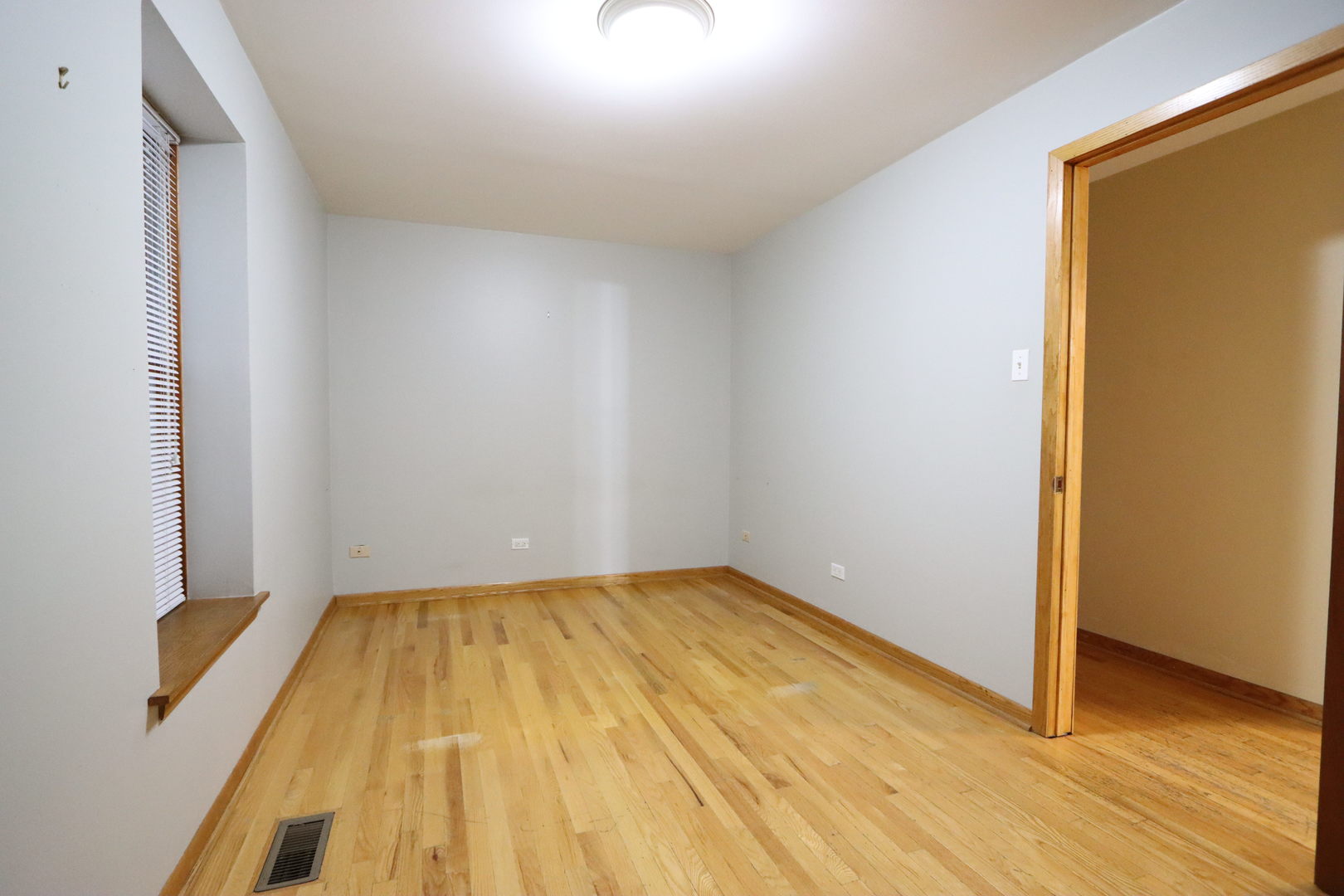 3217 South May Street Chicago, IL 60608 - Photo 20 of 27 a view of a room with wooden floor and bench