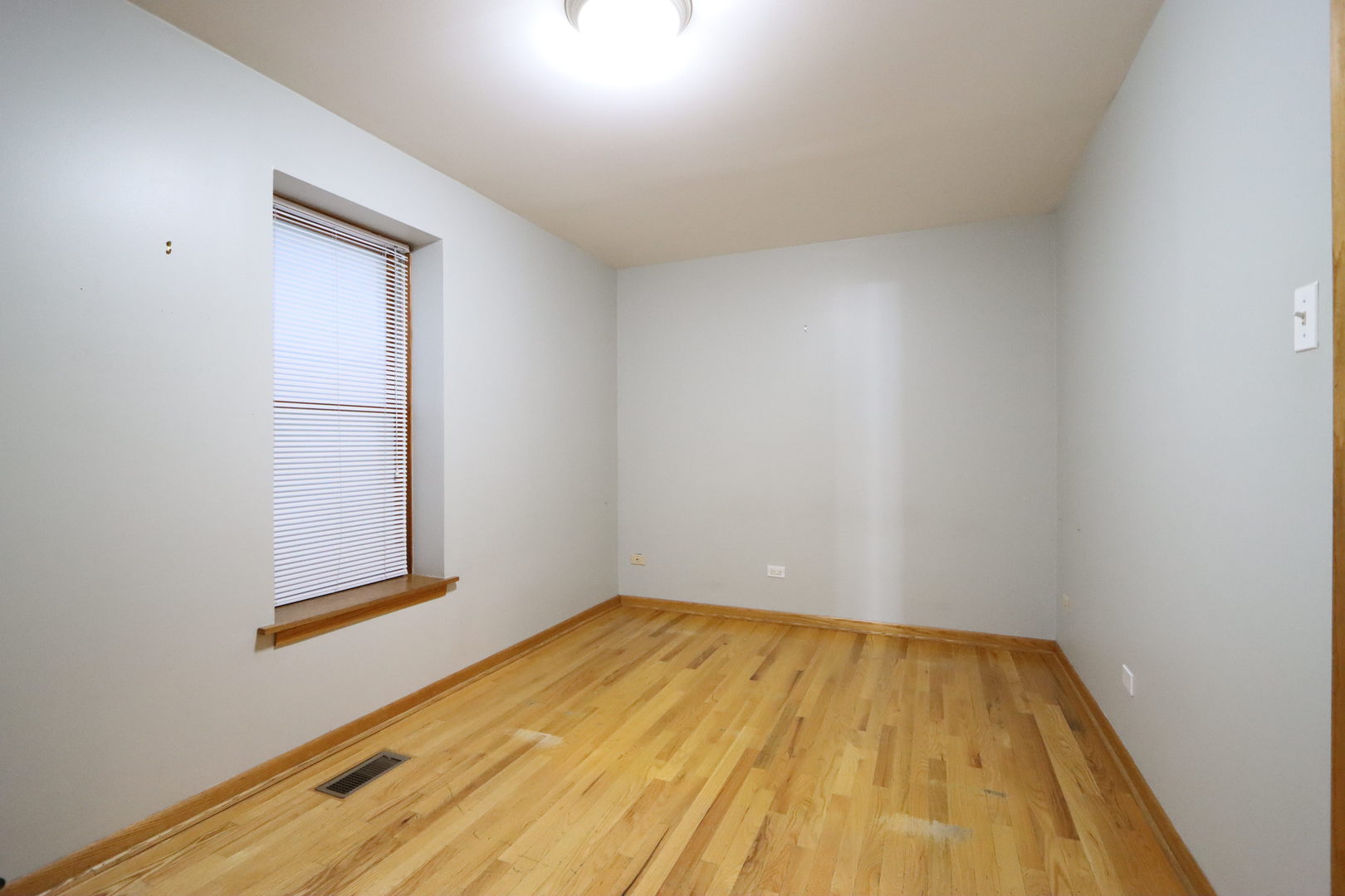 3217 South May Street Chicago, IL 60608 - Photo 21 of 27 a view of empty room with wooden floor