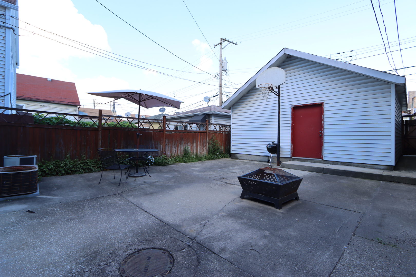 3217 South May Street Chicago, IL 60608 - Photo 23 of 27 a backyard of a house with barbeque oven fire pit and outdoor seating