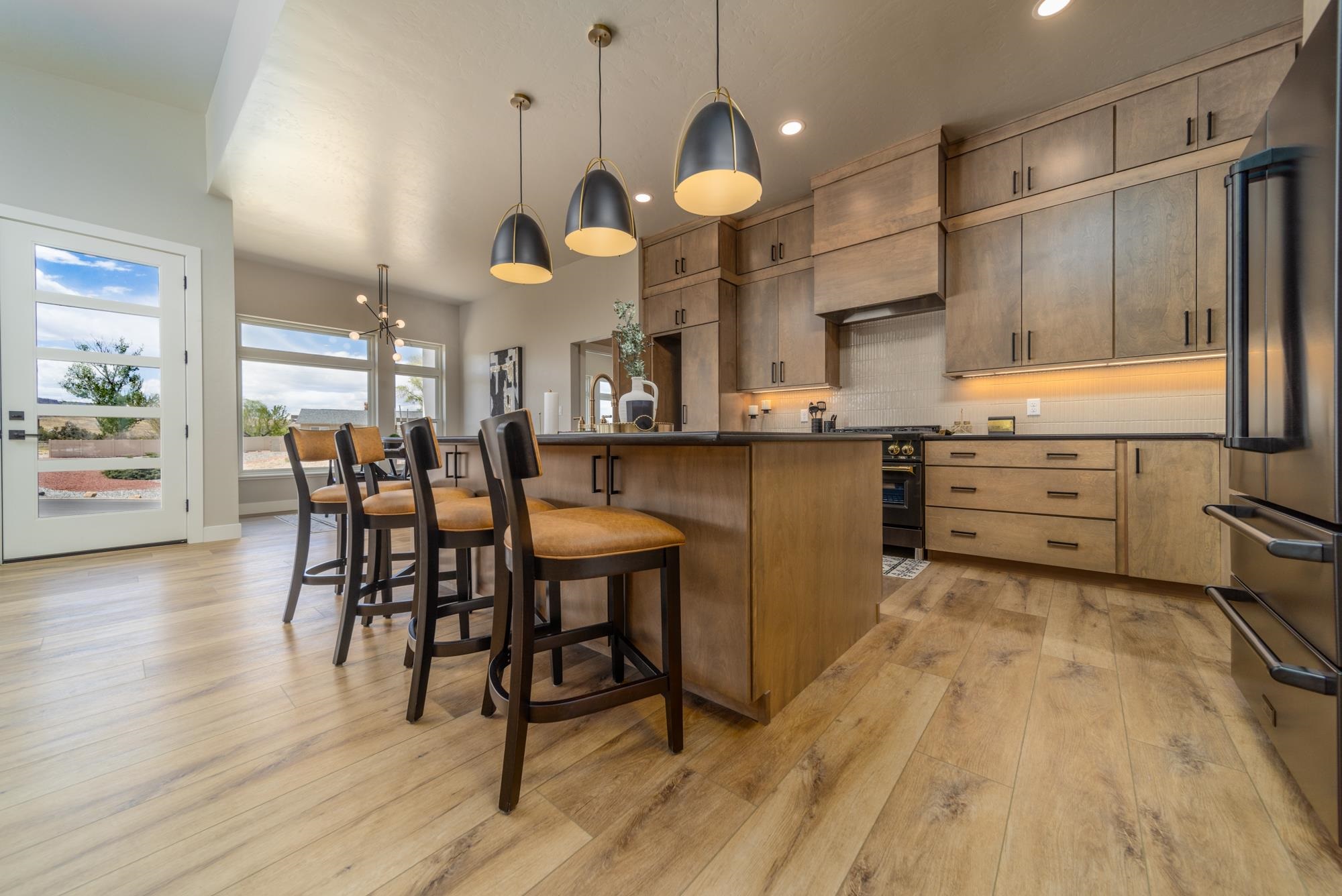 2260 Pyramid Peak Loop Grand Junction, CO 81507 - Photo 10 of 41 a kitchen with stainless steel appliances a dining table chairs and wooden floor