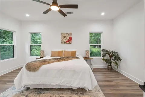 a spacious bedroom with a bed and a large window