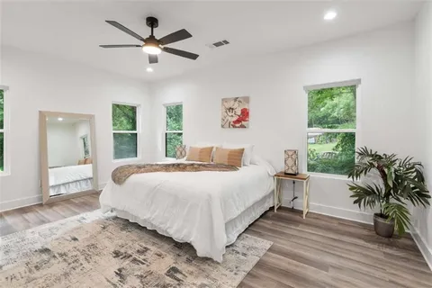 a bedroom with a large bed and a large window