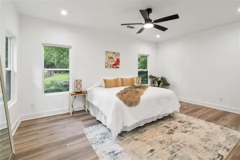 a bedroom with a large bed and a window