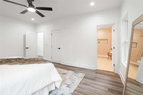 a spacious bedroom with a bed and a dresser