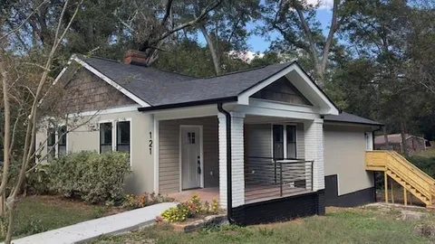 a front view of a house with a garden