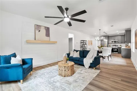 a living room with furniture and kitchen view