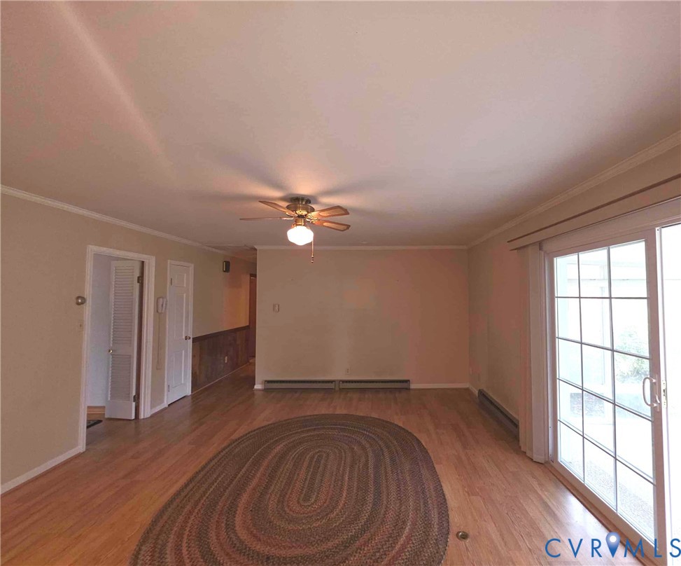 199 Ruritan Drive Emporia, VA 23847 - Photo 11 of 35 an empty room with wooden floor fan and windows