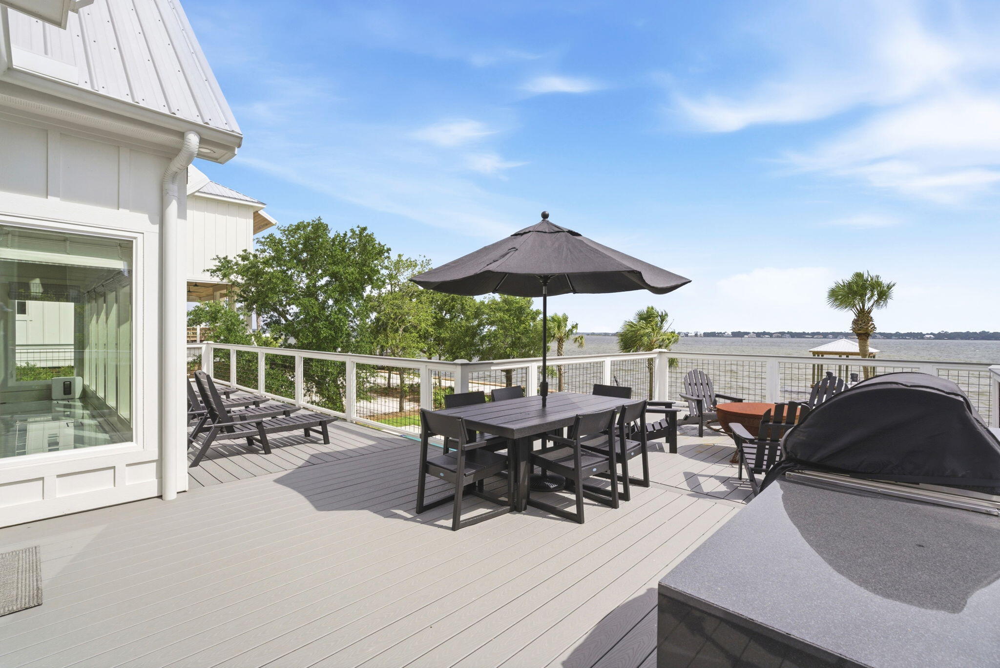 31061 Peninsula Drive Orange Beach, AL 36561 - Photo 25 of 93 a view of a patio with chairs and table under an umbrella