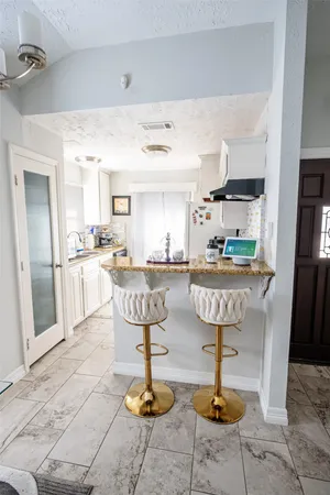 a kitchen with lots of counter space and furniture