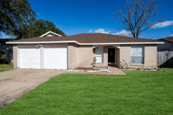 a front view of a house with yard and green space