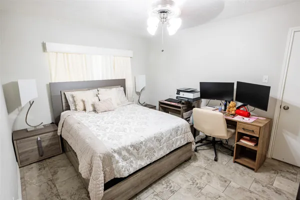 a bedroom with a bed and a mirror