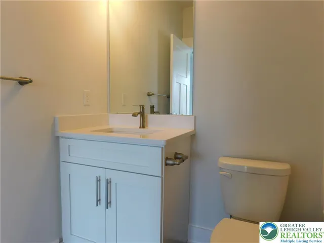 a bathroom with a sink a toilet and mirror